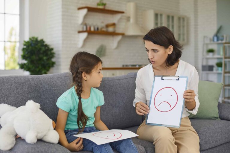 Psychologist with picture of unhappy emoji helping